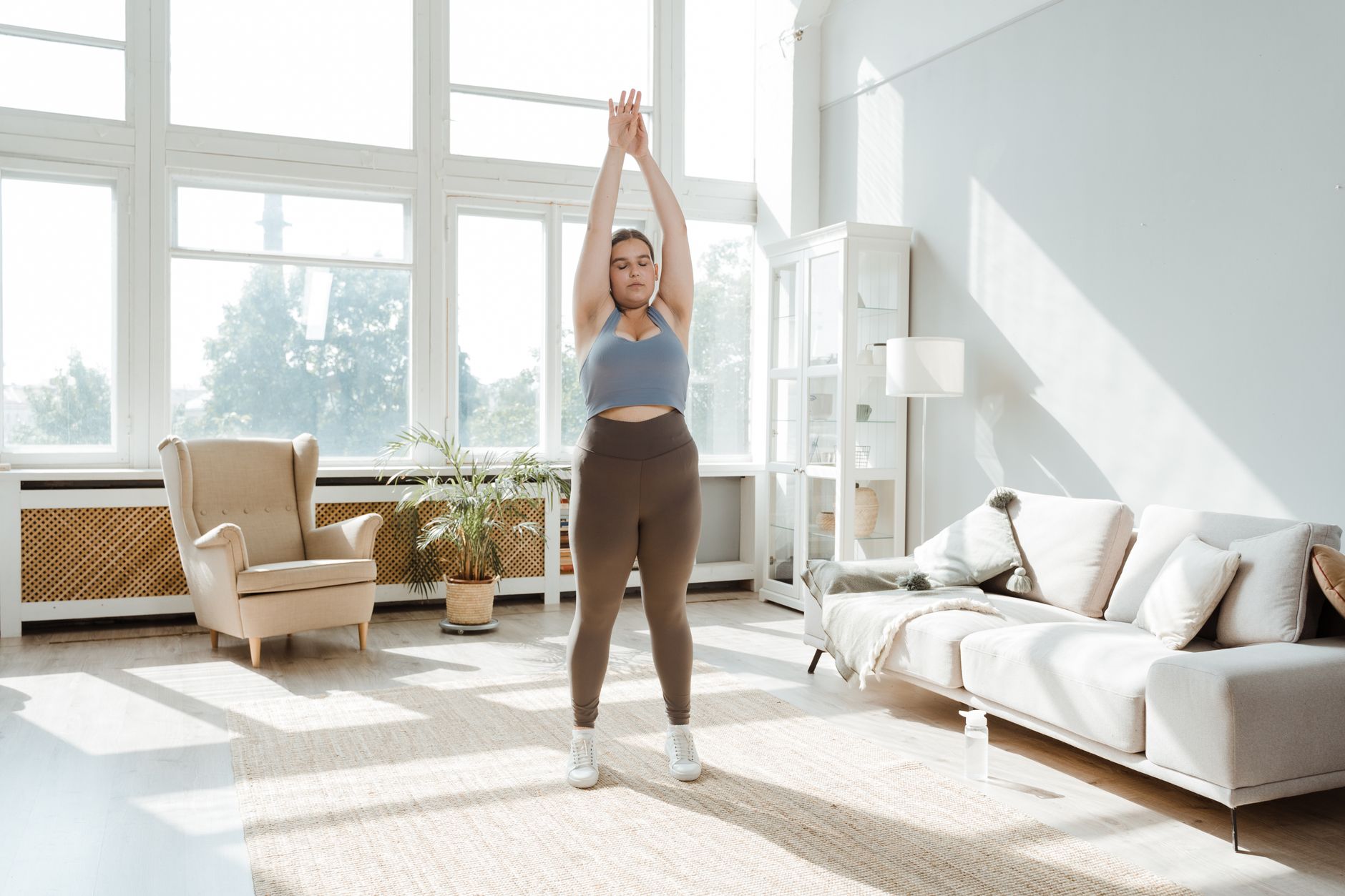 a woman stretching indoors