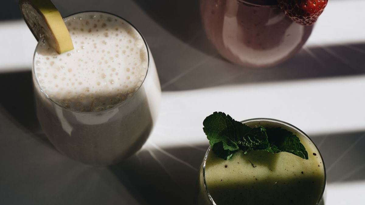 Protein smoothies in glasses on a sunlit table